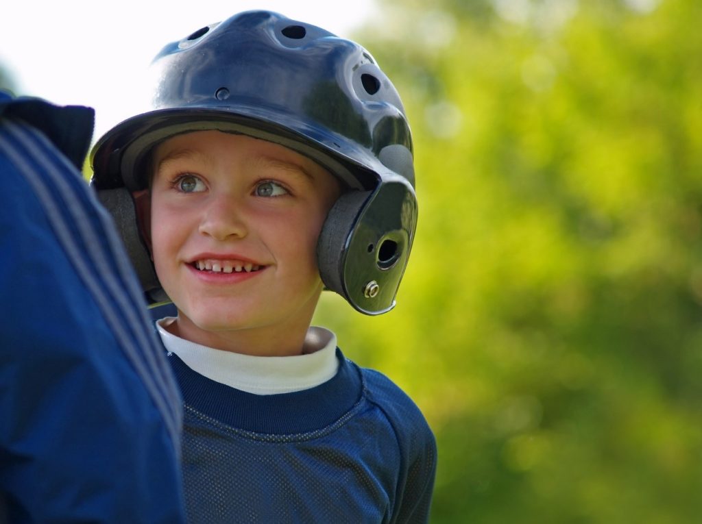 Little League Player Smiling with Helmet