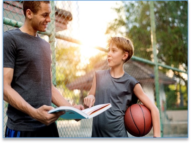 Parent Reading to Youth Basketball Player